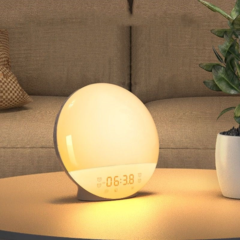 Sunrise lamp glowing on a bedside table