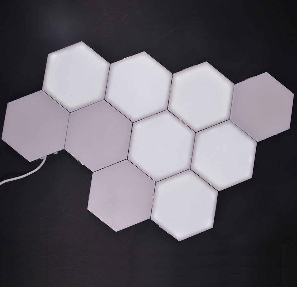 Hexagon wall panels arranged in a honeycomb on a wall