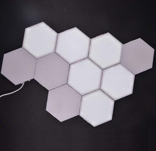 Hexagon wall panels arranged in a honeycomb on a wall