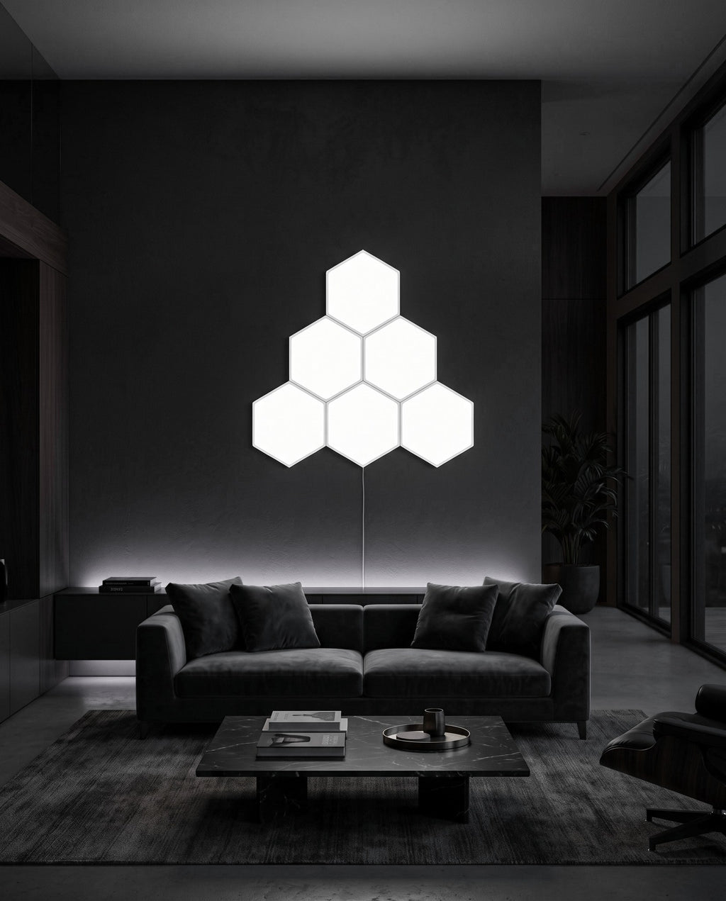 Six Aetheris Hexagon Light Panels in cool white on a dark living room wall above a sofa
