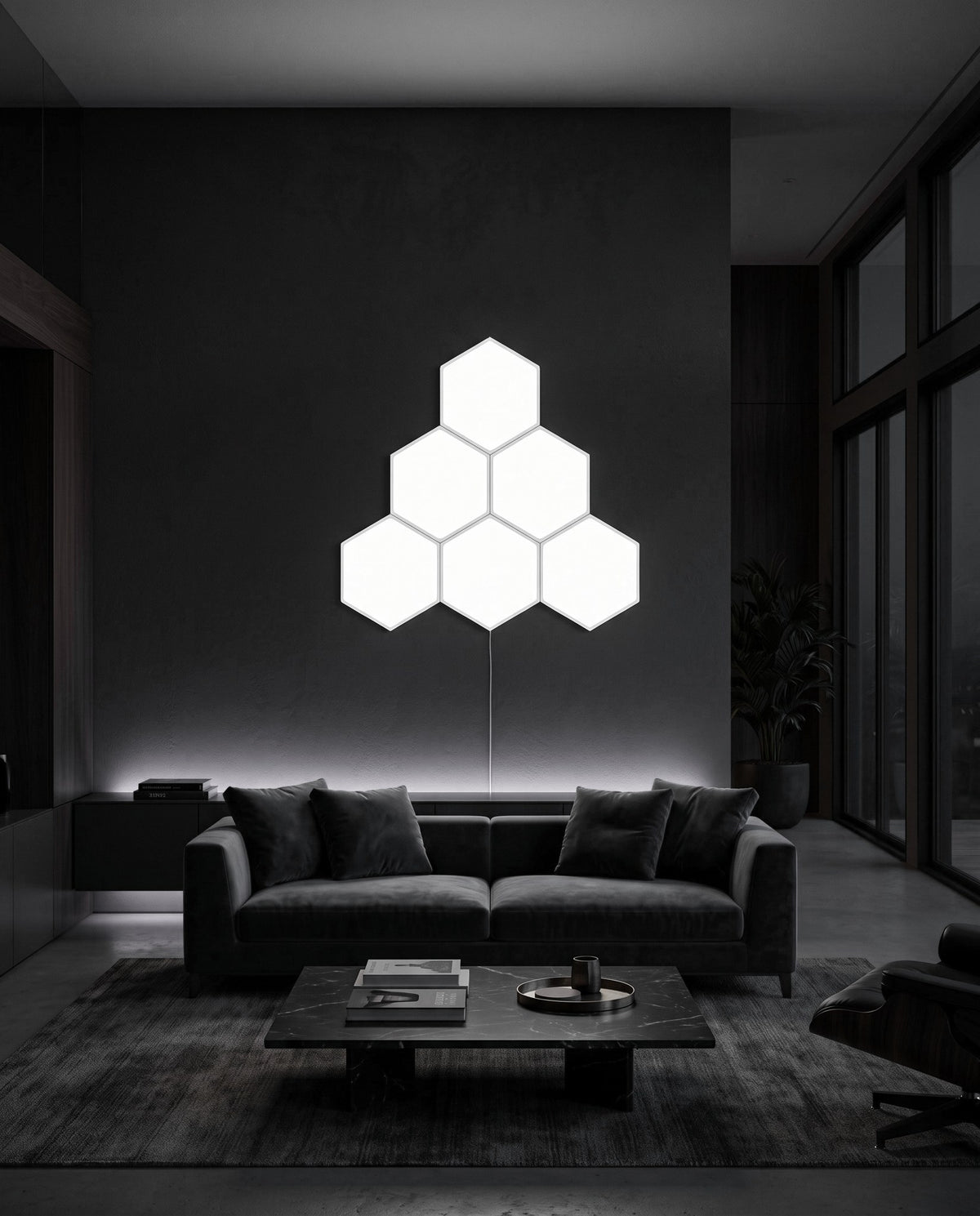 Six Aetheris Hexagon Light Panels in cool white on a dark living room wall above a sofa