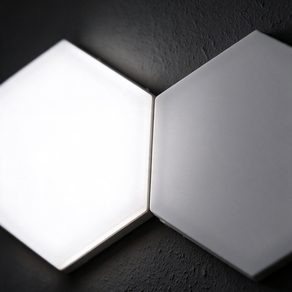 Close-up of two Aetheris Hexagon Light Panels lit cool white